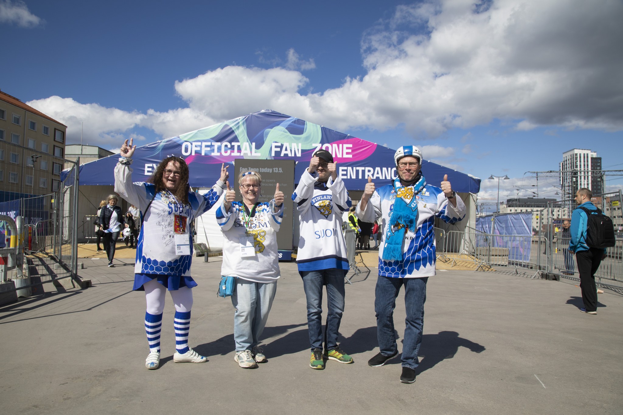 Hockey fans in fan zone with Finnish game jerseys