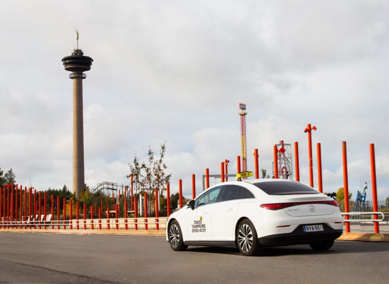 A Taksi Tampere taxi standing still with the Näsinneula Tower visible in the background.