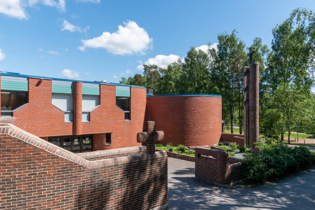 Church courtyard surrounded by a brick wall.