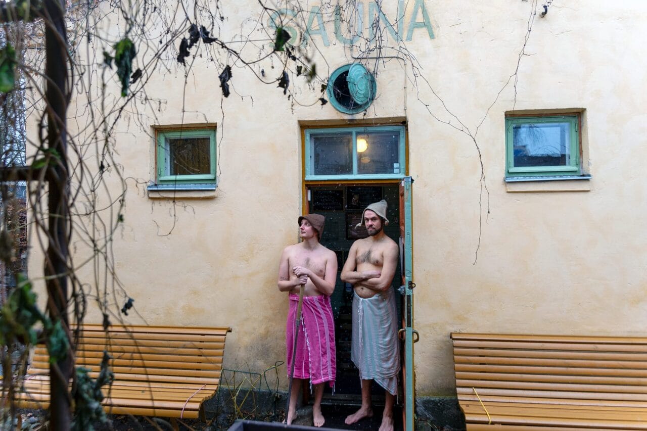 Matti and Juha standing in front of Rajaportti public sauna.
