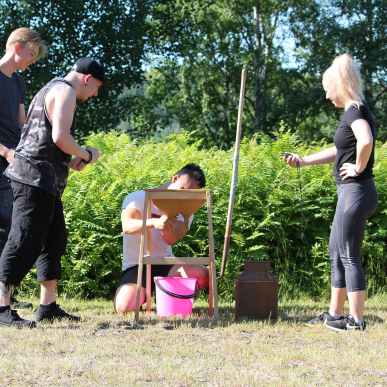 Team milking the cow during Farm Olympics.
