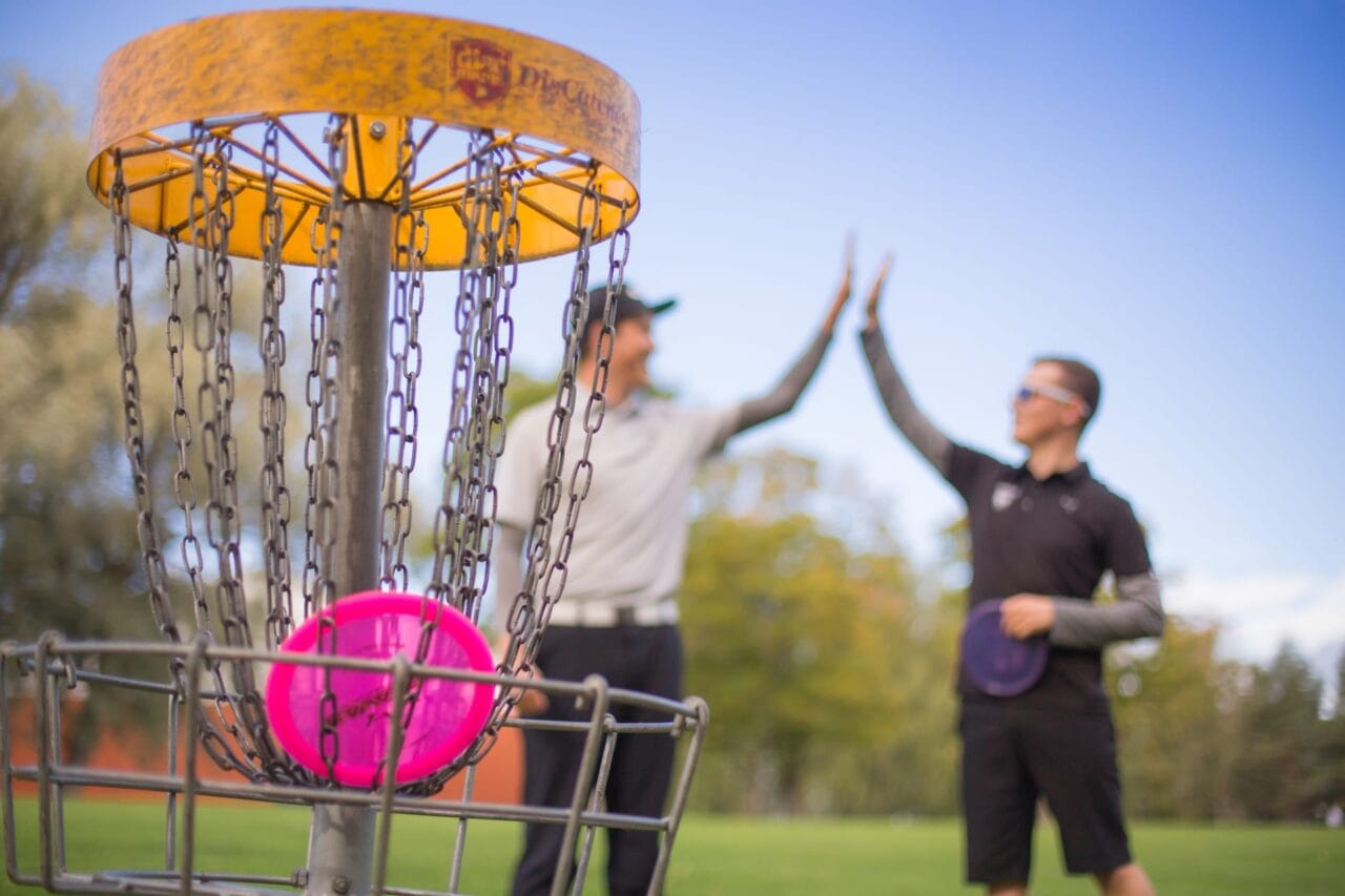 Men playing disc golf.