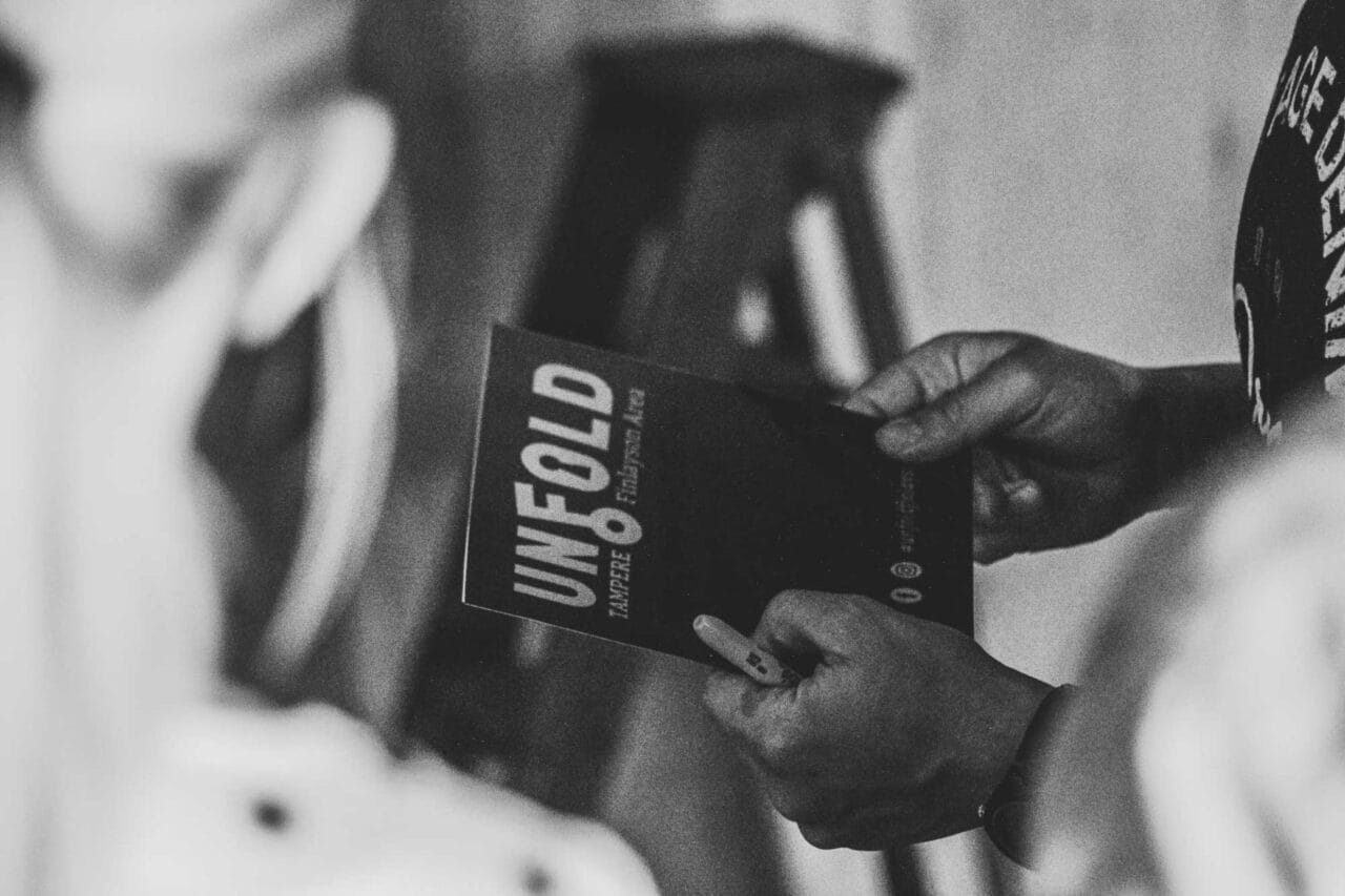 Players looking at the Unfold game book