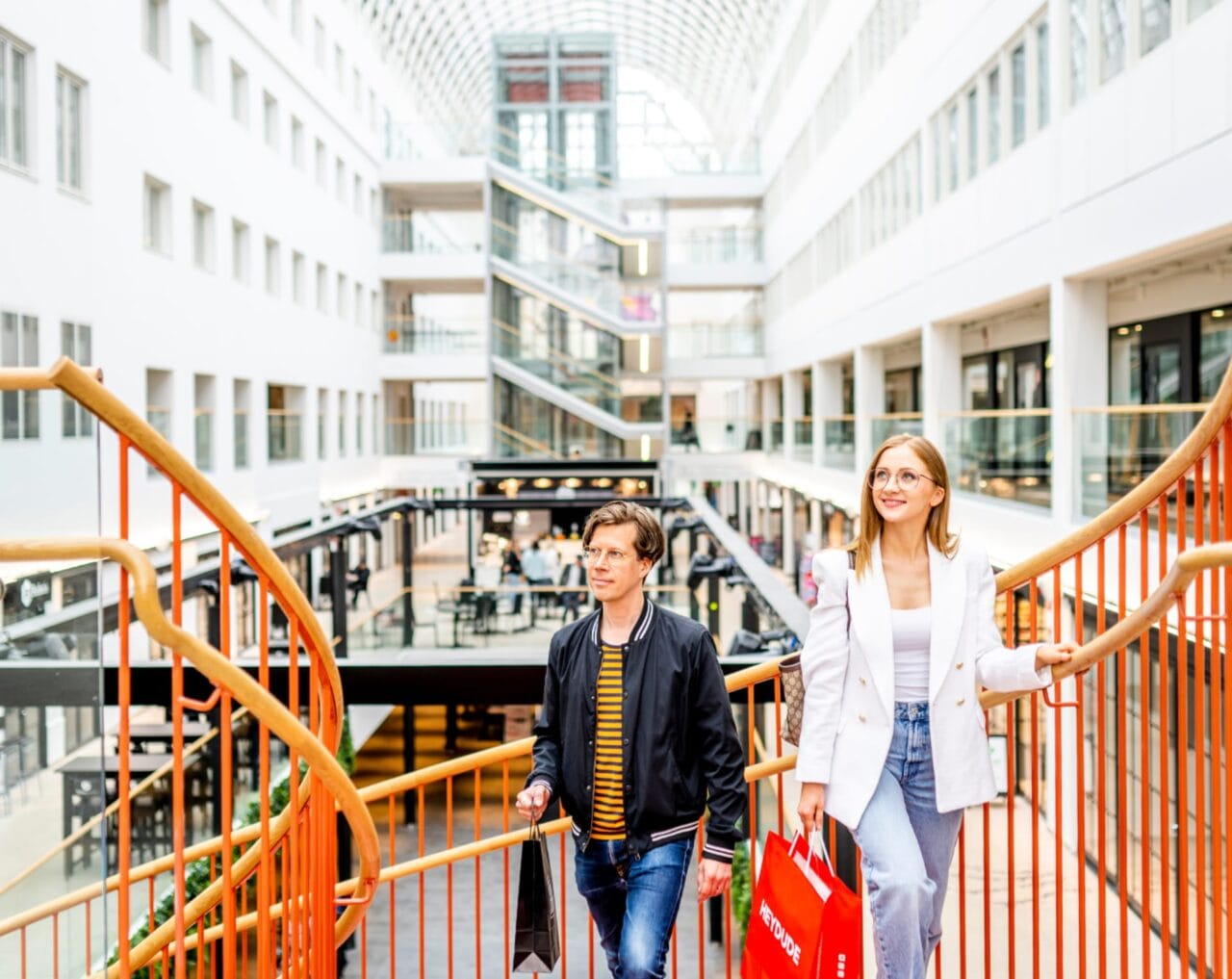 Two people walking up the stairs in Tullintori shopping center.