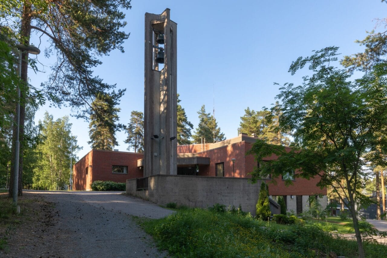 Teisko Church bell tower amidst trees.
