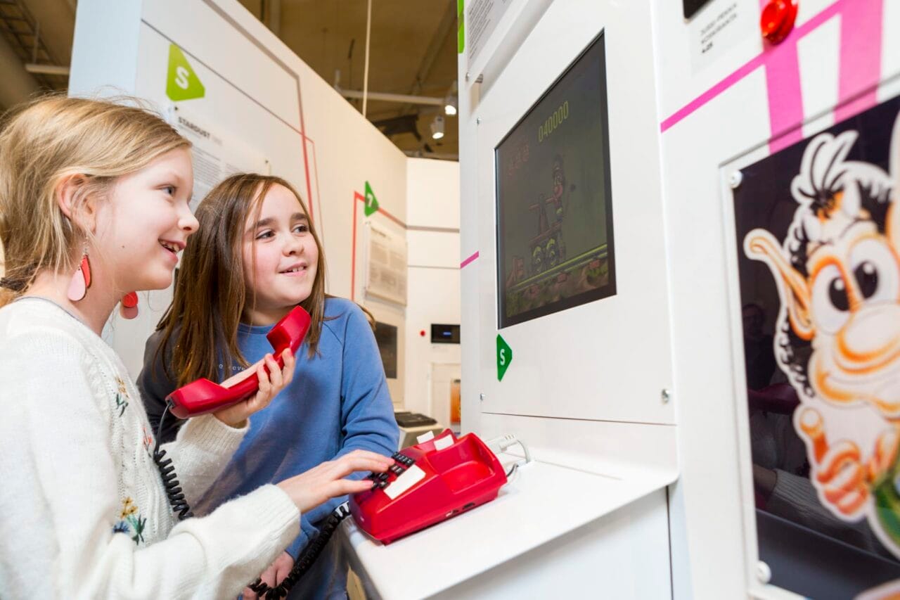 Children playing with a landline phone.