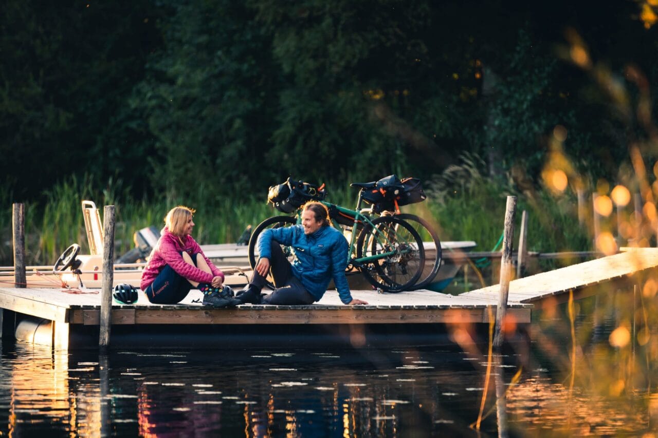 Couple with bicycles near lake