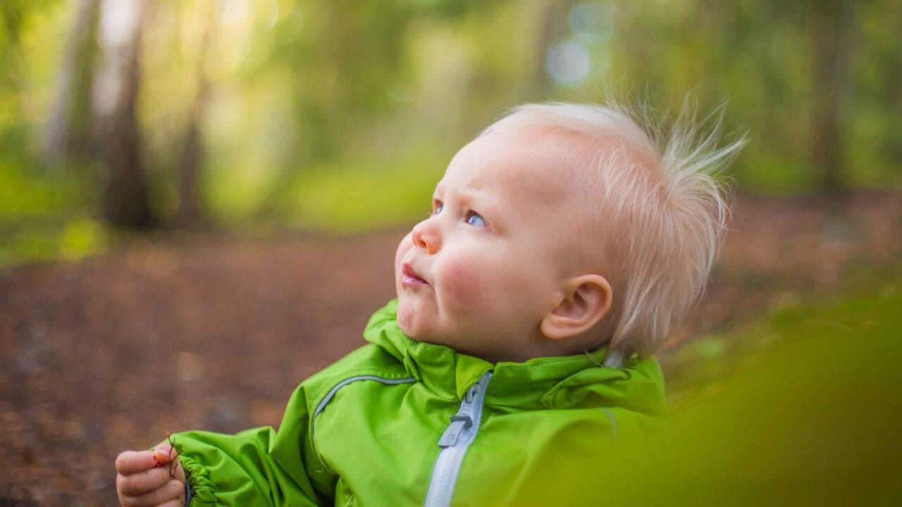 Child with green jacket.