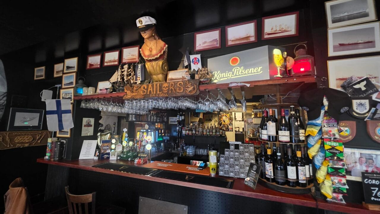 Interior of Sailor’s Bar & Grill in Tampere with ship photographs, maritime details and pub seating.