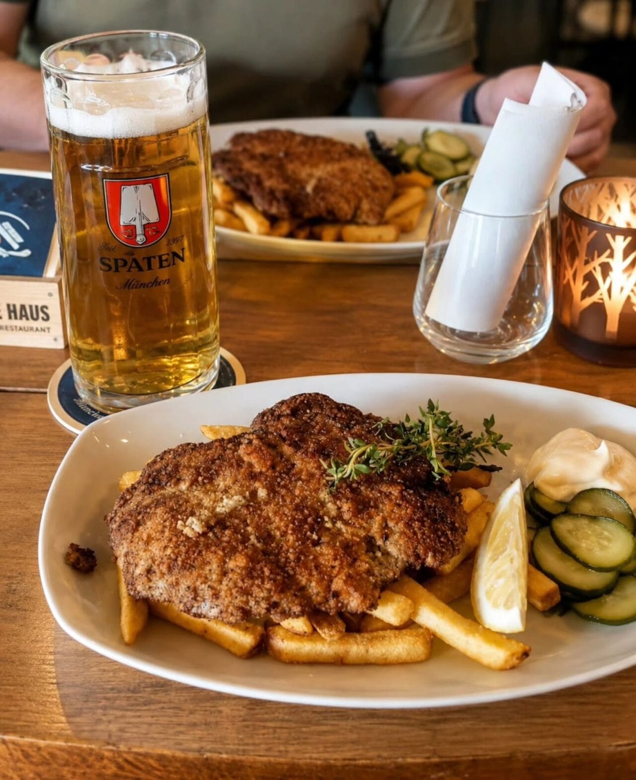 Schnitzel with fries, pickles and German Spaten beer at Schnitzelhaus in Tampere.